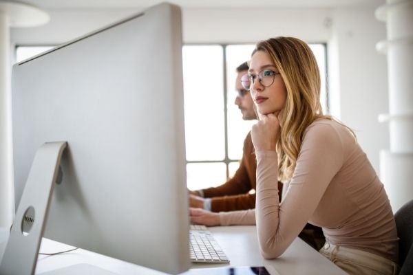 Photo of a marketing manager doing SEO keyword research on her computer